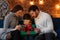 Parents presenting gift box to cute son. Christmas kids, child, portrait. Happy family spending Christmas morning