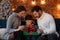 Parents presenting gift box to cute son. Christmas kids, child, portrait. Happy family spending Christmas morning