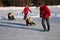 Parents pull children on sleds