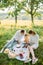 Parents read a book to their daughter in the park