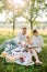 Parents read a book to their daughter in the park