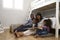 Parents Reading Story To Children In Their Bedroom