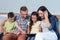 Parents sitting with son and daughter and looking at digital tablet