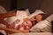 Parents Sleeping In Bed With Newborn Baby