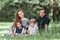 Parents with small two children on the lawn on a spring day