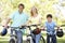 Parents And Son On Cycle Ride In Park