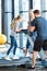 Parents supporting daughter workout on treadmill