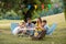 Parents of two children listening to their son talking during family picnic