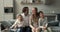 Parents and two children posing for family portrait at home