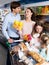 Parents with two kids buying fruit yoghurt