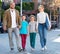 Parents with two teenagers going for shopping outdoors