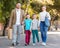 Parents with two teenagers going for shopping outdoors