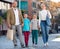 Parents with two teenagers going for shopping outdoors