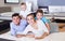 Parents with two young sons testing mattress in store