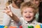 Parents watch their son play with colorful blocks.