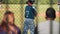 Parents watching kid at baseball game from the stands.