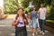 Parents waving goodbye to their daughter before school outdoors