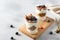 Parfait. Glasses with homemade granola with yogurt and fresh berries on white concrete background. Dieting, recipe. Side view,