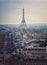 Paris cityscape with view to the Eiffel Tower, France. Beautiful parisian architecture with historic buildings, landmarks and busy