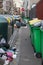 Paris dirty sidewalks loaded with recycling containers and garbage bins