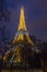 Paris Eiffel Tower at night fully illuminated with holiday lights