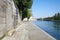 Paris, empty Seine river docks with stone bench in a sunny day