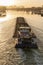 Paris, France - 01 30 2022: Quays of the Seine. View of the freight of a barge sailing along the Seine and The Defense district at