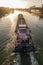 Paris, France - 01 30 2022: Quays of the Seine. View of the freight of a barge sailing along the Seine and The Defense district at