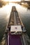 Paris, France - 01 30 2022: Quays of the Seine. View of the freight of a barge sailing along the Seine and The Defense district at