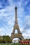 Paris, France, 09/10/2019: Eiffel Tower with a tourist bus on a background of bright clear blue sky. Vertical