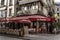 Paris, France, 10/10/2019: Street city cafe with people relaxing and working online. Toning