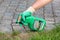 Paris, France - August 15, 2018 : Gardener using Roundup herbicide in a french garden. Roundup is a brand-name of an herbicide con