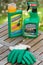 Paris, France - August 15, 2018 : Herbicide on a wooden table in a french garden. Roundup is a brand-name of an herbicide containi