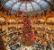 Paris, France - December 15: Massive Christmas tree decoration with flowers inside Galerie Layfayette shopping mall