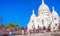 PARIS, FRANCE - DECEMBER 2012: Tourists visit Sacred Heart Cathedral in Montmartre. The city attracts 40 million people every year