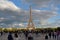 Paris, France. Eiffel Tower from Trocadero. Viewpoint crowded with tourists. Rainy day, sunset light with shadows.