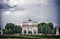 Paris, France - June 02, 2017: Arc de Triomphe du Carrousel in Louvre Palace. Arch monument and green trees on blue sky