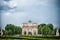 Paris, France - June 02, 2017: Arc de Triomphe du Carrousel in Louvre Palace. Arch monument and green trees on blue sky. Architect