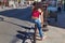 PARIS, FRANCE - JUNE 23, 2017: Unknown young girl sitting on the fence near the road on Rue de Rivoli street in the center of