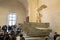 Paris, France - March 31, 2019: People on stairs look at The Winged Victory of Samothrace.