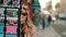 Paris, France - October, 2019: Stylish Parisian woman in beret, beige trench coat and sunglasses fooling around near a