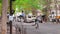 Paris, France - October, 2019: A typical French street. A cyclist rides along the roadway. A pedestrian walks past the