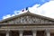 Paris, France. The Pantheon, Latin Quarter. Facade closeup, columns, capitals, tympanum with sculptures and french flag.