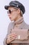 Paris Lady in fashion elegant outfit. Trendy cap and sunglasses. Beige velvet clutch. Style in details. Fall winter season.