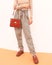 Paris Model. Details of everyday look. Casual vintage outfit. Plaid pants.and stylish retro accessories bag and shoes