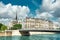 Paris, panorama over river Seine with Notre-Dame cathedral from the back on a bright day in Spring with gorgeous dramatic clouds