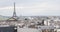 Paris rooftops view and Eiffel Tower in a cloudy day in France