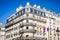 PARIS - September 3, 2019 : Traditional Haussmann building and french flag view from a Parisian Boulevard