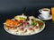 Parisian breakfast - corn porridge, croissant with sliced chicken, rucola, tomato and cheese salad with pesto sauce, boiled