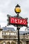 Parisian metro sign with a lamppost Paris France